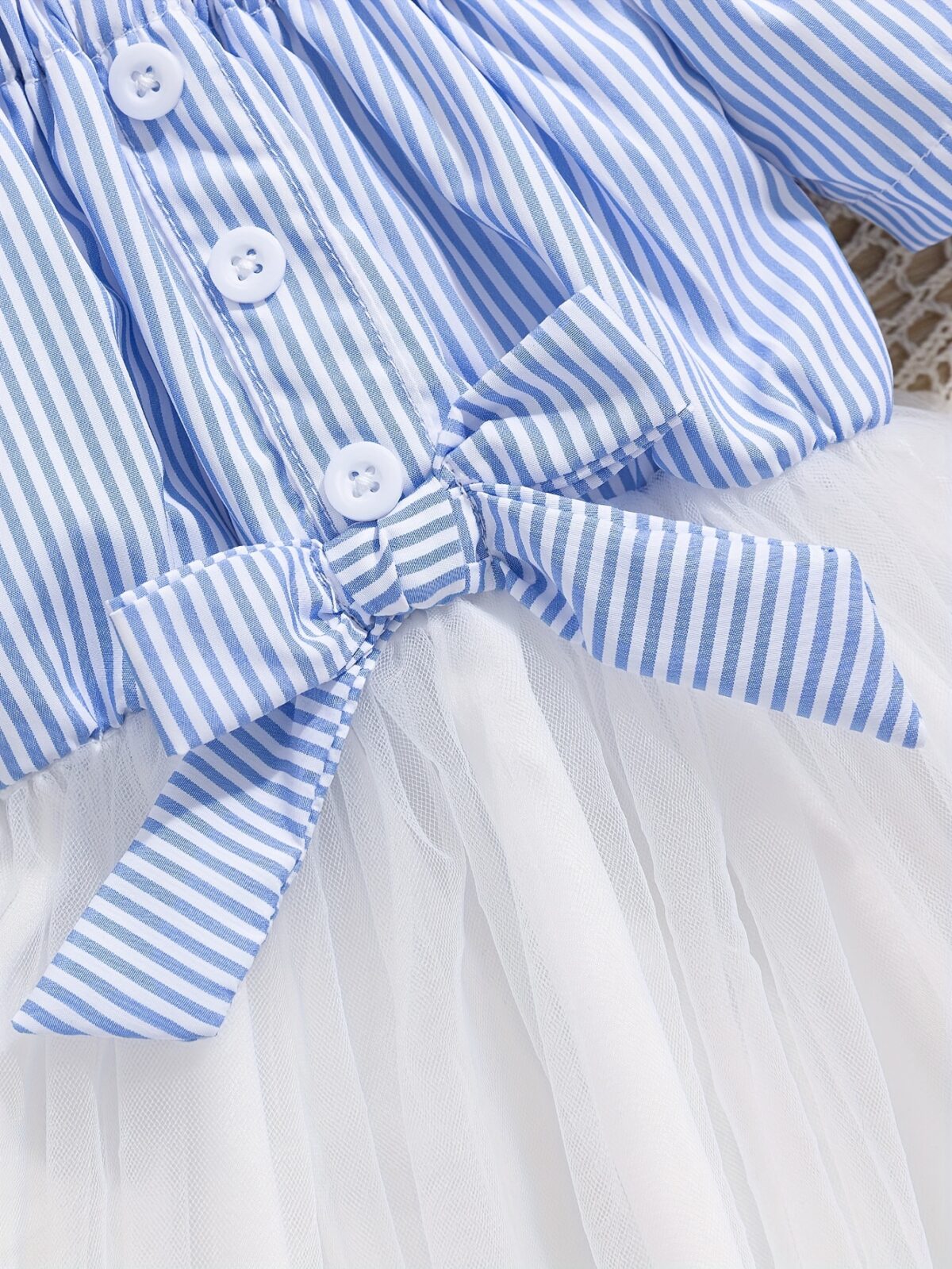 Adorable baby girl wearing a cute and playful summer stripe sundress perfect for playtime