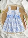 Model wearing a charming Provence Summer Bow Dress in a field of flowers The dress features a flattering silhouette and a cute bow