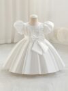 Adorable girl twirling in a lavender colored party dress perfect for birthdays and special occasions The dress features exquisite detailing and a flattering silhouette