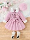 Adorable baby girl wearing a cozy corduroy dress set in fall colors perfect for autumn and winter The outfit includes a dress and matching pants
