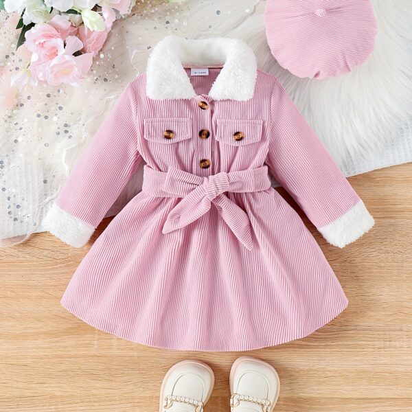 Adorable baby girl wearing a cozy corduroy dress set in fall colors perfect for autumn and winter The outfit includes a dress and matching pants