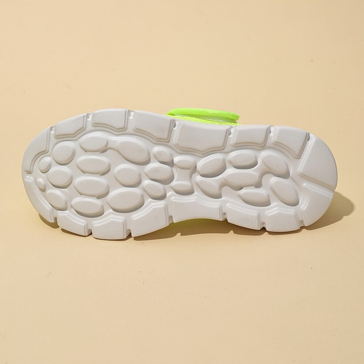 Adorable toddler wearing Newnesss Summer Breeze Sneakers running playfully outdoors on a sunny day