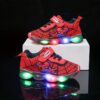 Boy wearing stylish Marvel Spider Man LED light up sneakers running and playing The sneakers light up showcasing vibrant colors