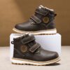 Child wearing stylish and warm Newness Adventure Ready Kids Snow Boots playing in the snow