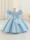 Adorable girl twirling in a lavender colored party dress perfect for birthdays and special occasions The dress features exquisite detailing and a flattering silhouette