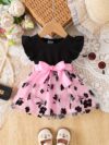 Adorable little girl twirling in a beautiful summer floral mesh dress from Newness The dress is lightweight and perfect for warm weather
