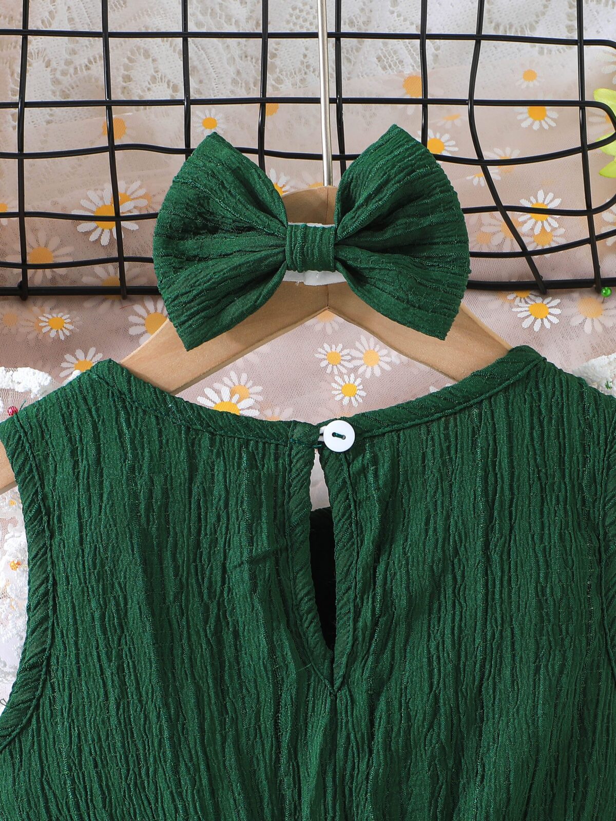 Toddler girl wearing a charming emerald green summer dress ideal for playing outdoors