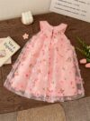 Adorable little girl twirling in a beautiful rosebud garden floral print dress perfect for weddings or a casual day out