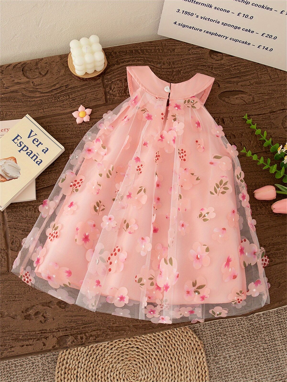 Adorable little girl twirling in a beautiful rosebud garden floral print dress perfect for weddings or a casual day out