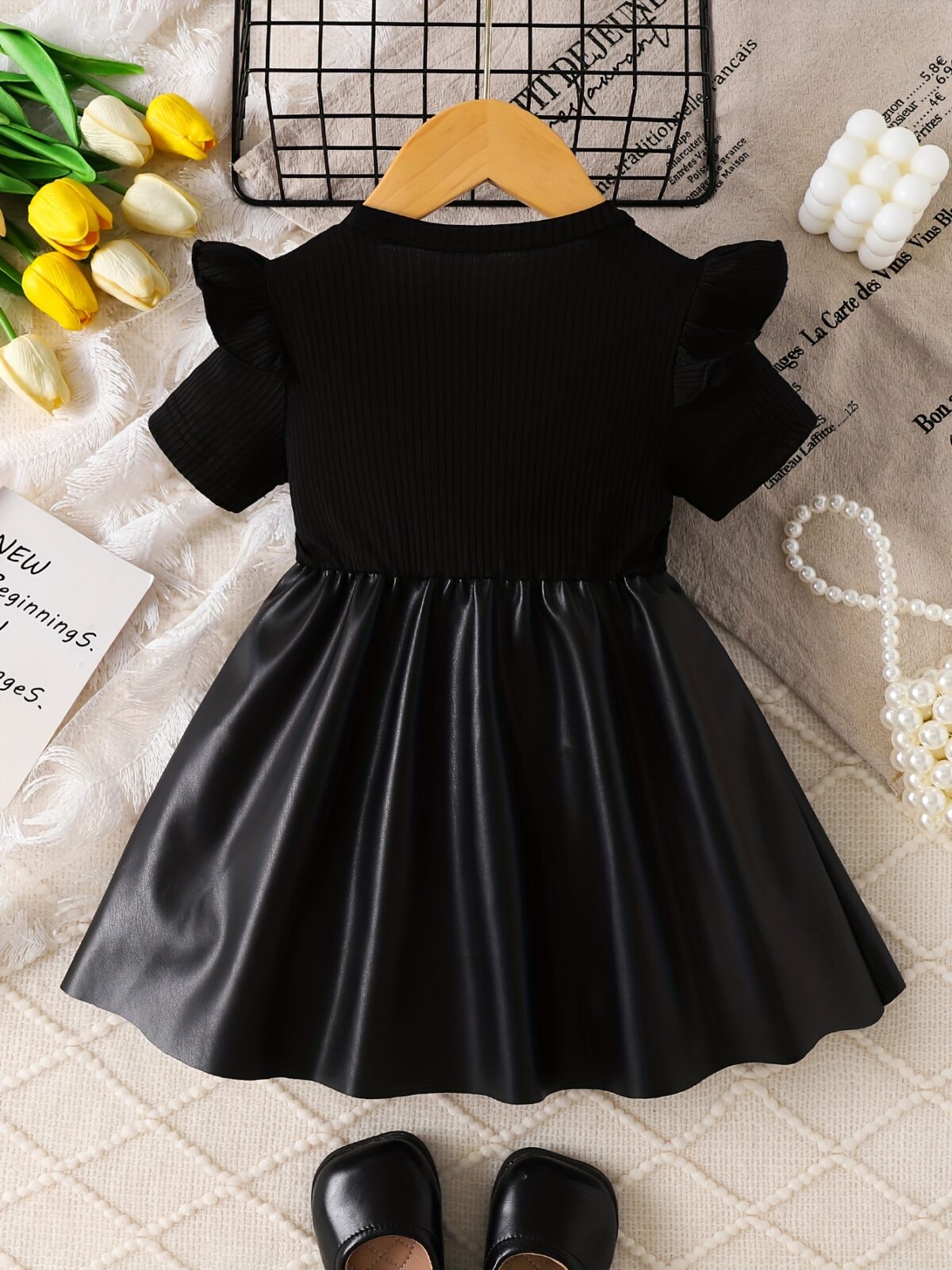 Adorable baby girl wearing a charming Little Darling Baby Bow Dress perfect for parties or playdates The dress features a beautiful bow detail