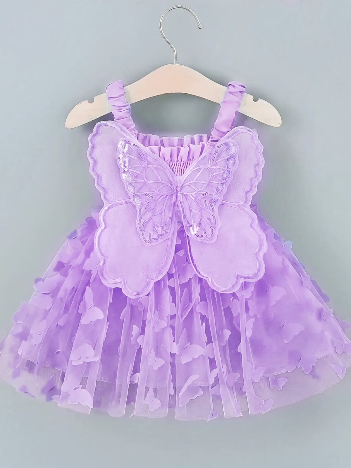Adorable baby girl wearing a Flutterby Mesh Butterfly Dress a perfect summer outfit from Newness