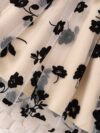Adorable little girl twirling in a beautiful summer floral mesh dress from Newness The dress is lightweight and perfect for warm weather