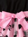Adorable little girl twirling in a beautiful summer floral mesh dress from Newness The dress is lightweight and perfect for warm weather