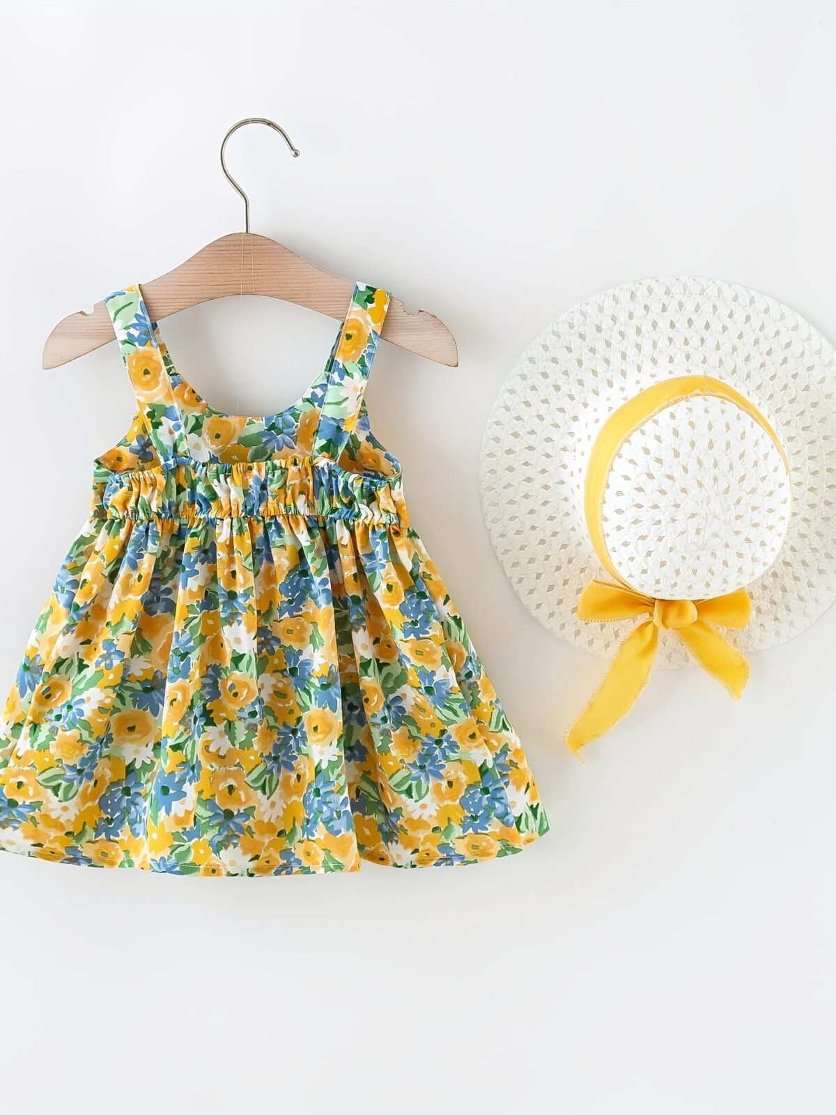 Baby girl wearing adorable Newness floral print dress and hat set perfect for summer