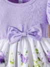 Adorable baby girl wearing a charming butterfly print dress from Newness perfect for spring and summer
