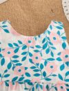 Adorable girl wearing a beautiful floral print summer dress perfect for a beach party