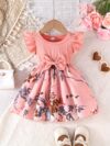 Adorable girl wearing a vibrant Summer Bloom floral print dress perfect for summer The dress features a playful colorful floral pattern