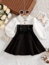 Adorable baby girl wearing a Petite Darling Color Block Dress perfect for birthdays or back to school photos The dress features a vibrant color block design
