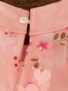 Adorable little girl twirling in a beautiful rosebud garden floral print dress perfect for weddings or a casual day out