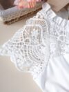 Adorable girl wearing a white Summer Bloom Lace Trim Dress showcasing its delicate lace details and summery style
