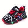 Boy wearing stylish Marvel Spider Man LED light up sneakers running and playing The sneakers light up showcasing vibrant colors