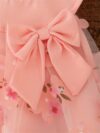 Adorable little girl twirling in a beautiful rosebud garden floral print dress perfect for weddings or a casual day out