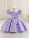 Adorable girl twirling in a lavender colored party dress perfect for birthdays and special occasions The dress features exquisite detailing and a flattering silhouette