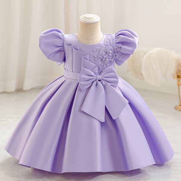 Adorable girl twirling in a lavender colored party dress perfect for birthdays and special occasions The dress features exquisite detailing and a flattering silhouette