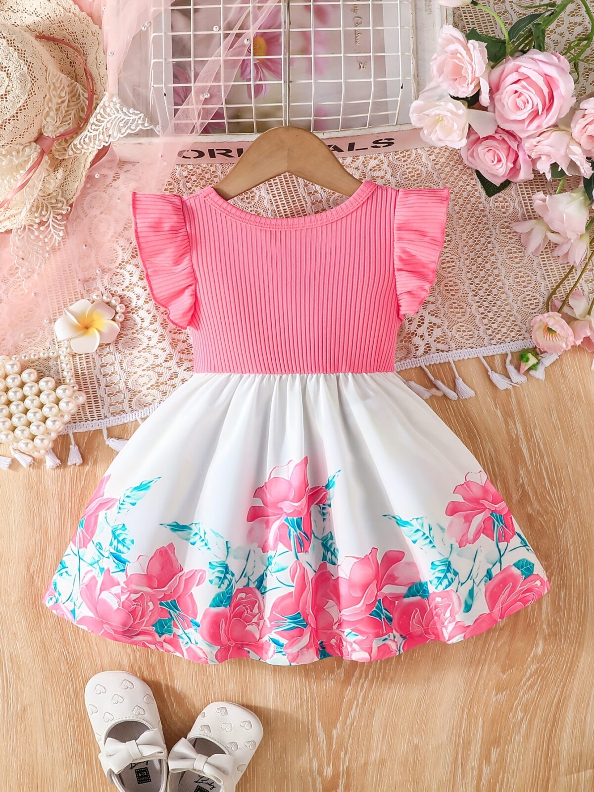 A little girl wearing a charming summer floral print dress