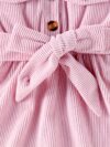 Adorable baby girl wearing a cozy corduroy dress set in fall colors perfect for autumn and winter The outfit includes a dress and matching pants