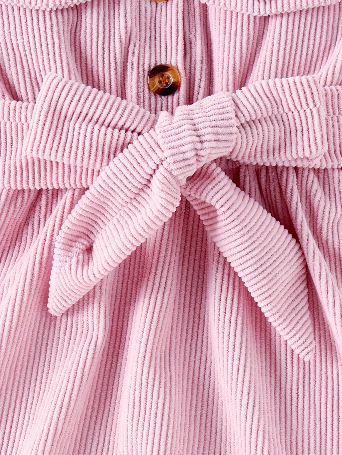 Adorable baby girl wearing a cozy corduroy dress set in fall colors perfect for autumn and winter The outfit includes a dress and matching pants