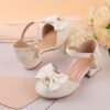 Adorable girls Pearl  Bow Mary Janes in white perfect for weddings parties and special occasions Featuring delicate pearls and charming bows