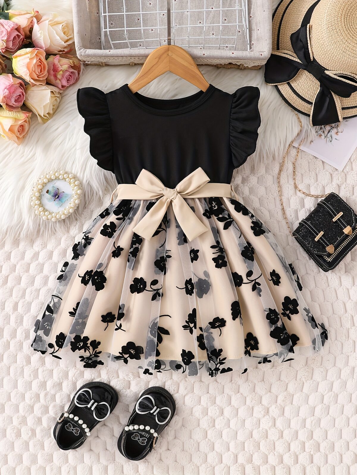 Adorable little girl twirling in a beautiful summer floral mesh dress from Newness The dress is lightweight and perfect for warm weather