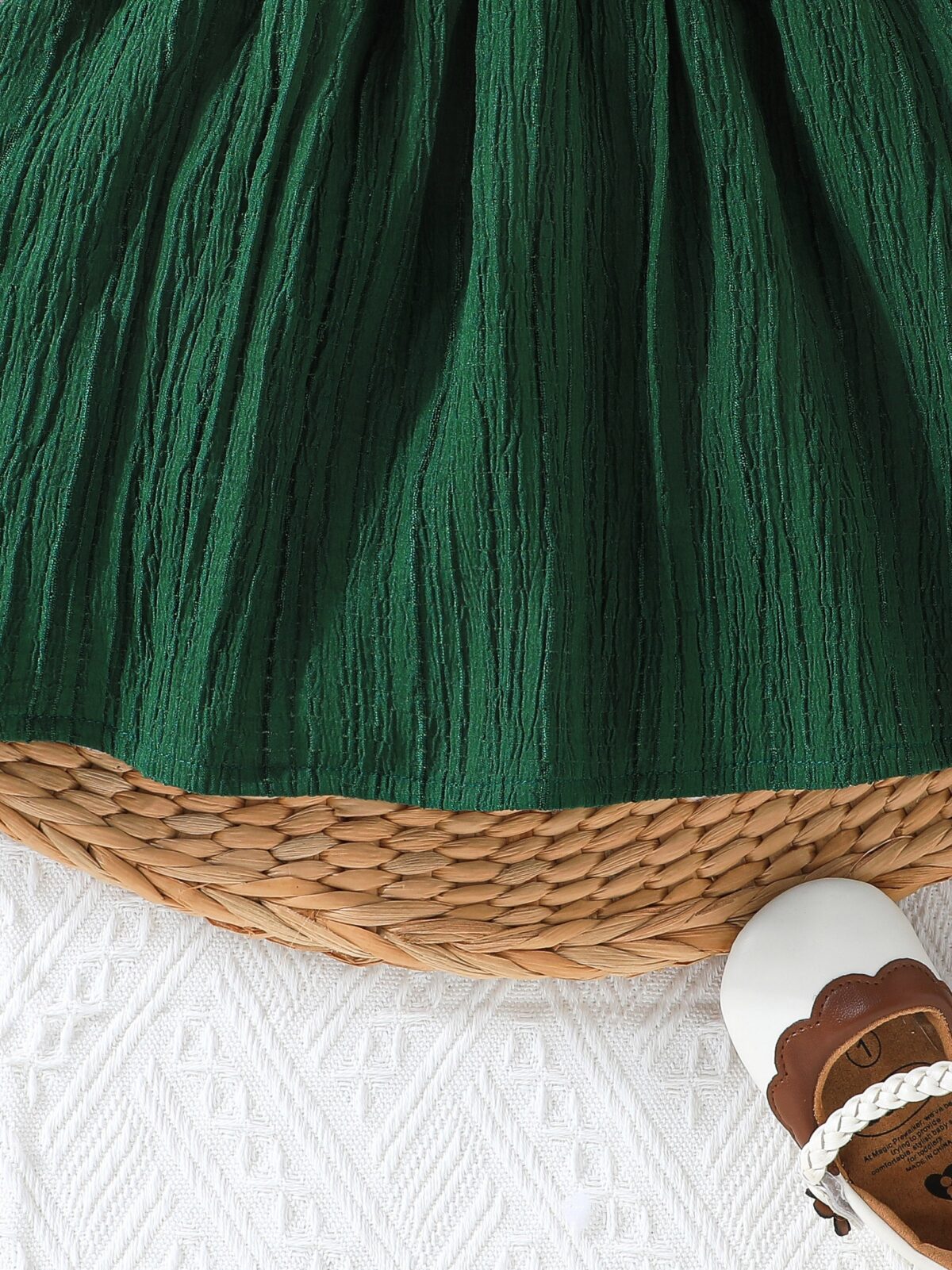 Toddler girl wearing a charming emerald green summer dress ideal for playing outdoors