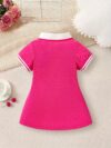 Adorable baby girl in a charming rose patterned summer dress perfect for playdates or special occasions