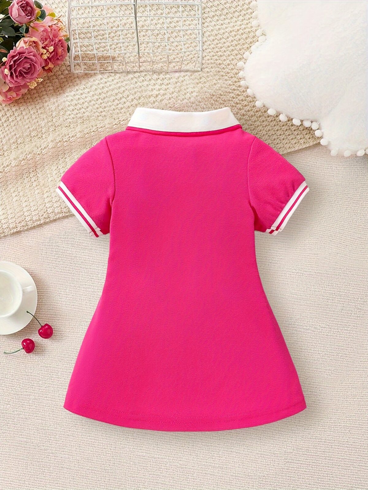 Adorable baby girl in a charming rose patterned summer dress perfect for playdates or special occasions
