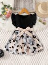 Adorable little girl twirling in a vibrant Summer Bloom floral print dress from Newness perfect for summer