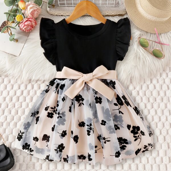 Adorable little girl twirling in a vibrant Summer Bloom floral print dress from Newness perfect for summer