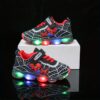 Boy wearing stylish Marvel Spider Man LED light up sneakers running and playing The sneakers light up showcasing vibrant colors