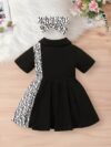 Adorable little girl wearing a stylish and comfy Newness summer letter print dress perfect for a playdate