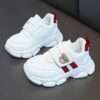Adorable kids Playful Striped Sneakers with a cute bear charm showcasing Newnesss stylish and comfortable design