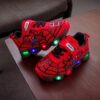 Boy wearing stylish Marvel Spider Man LED light up sneakers running and playing The sneakers light up showcasing vibrant colors