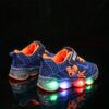 Boy wearing stylish Marvel Spider Man LED light up sneakers running and playing The sneakers light up showcasing vibrant colors