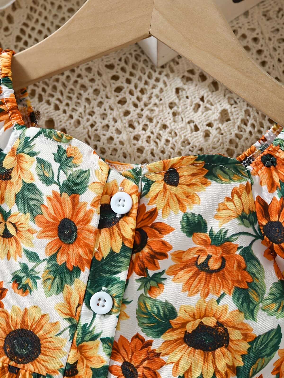 Baby girl wearing an adorable sunflower floral print dress perfect for summer