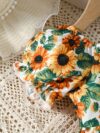 Baby girl wearing an adorable sunflower floral print dress perfect for summer