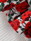 Adorable baby girl wearing a Rosalind floral print dress from Newness The dress features a charming floral pattern and is perfect for special occasions or everyday wear