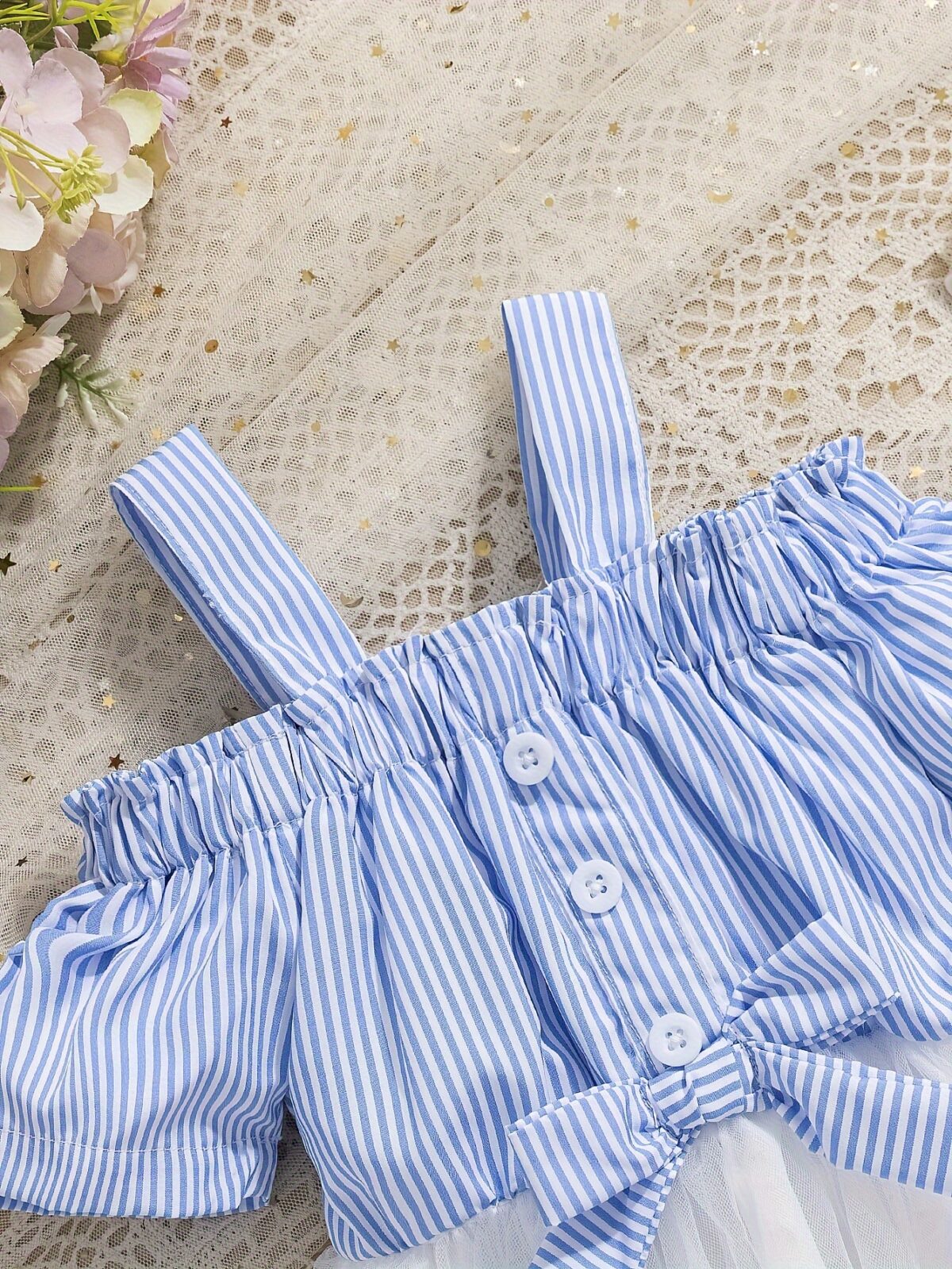 Adorable baby girl wearing a cute and playful summer stripe sundress perfect for playtime