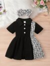 Adorable little girl wearing a stylish and comfy Newness summer letter print dress perfect for a playdate