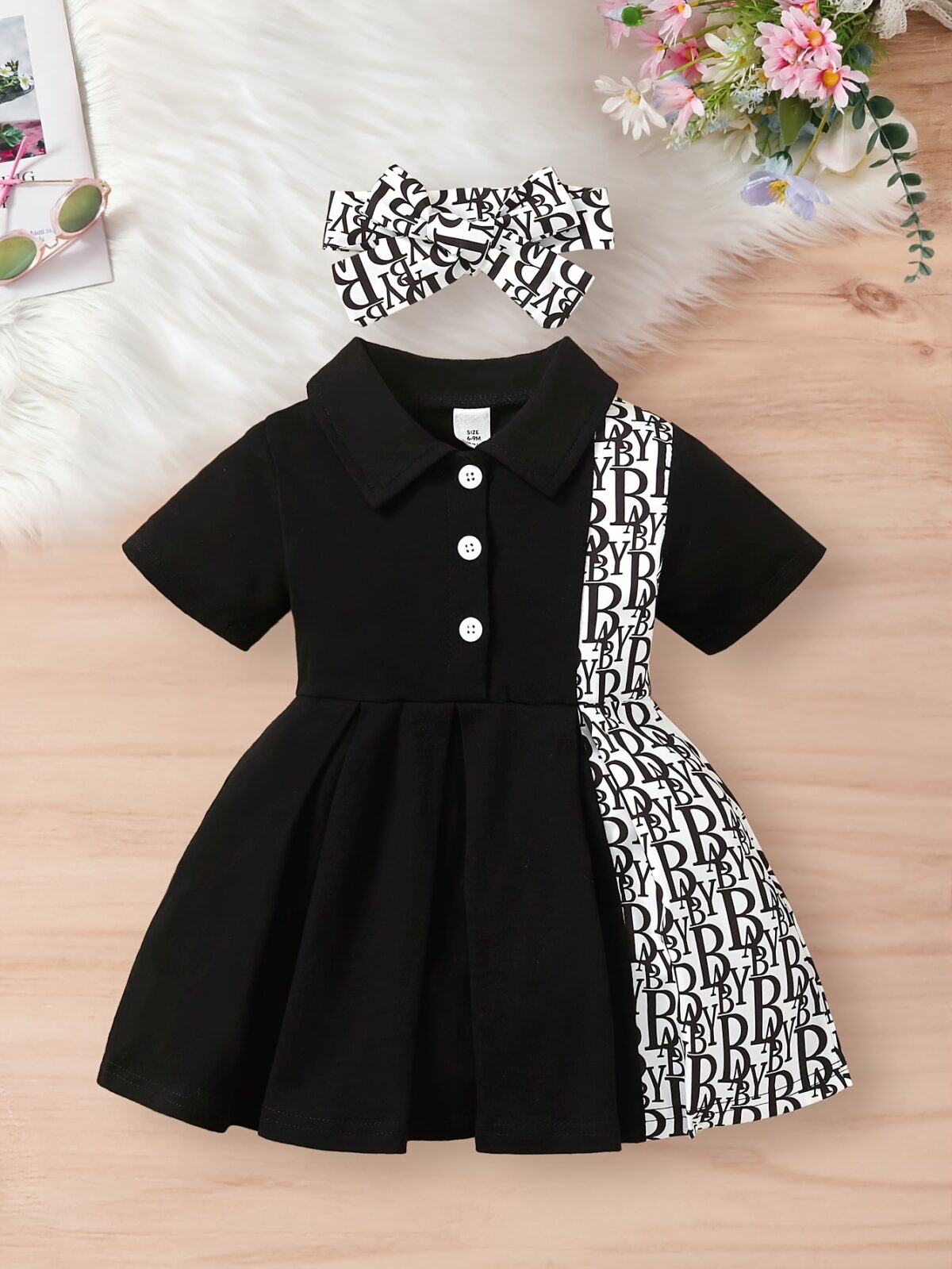 Adorable little girl wearing a stylish and comfy Newness summer letter print dress perfect for a playdate
