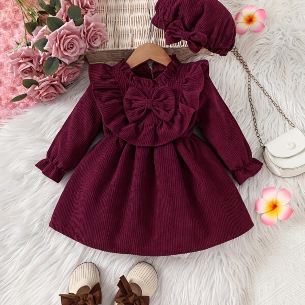 Adorable baby girl wearing a charming corduroy dress perfect for playtime or special occasions